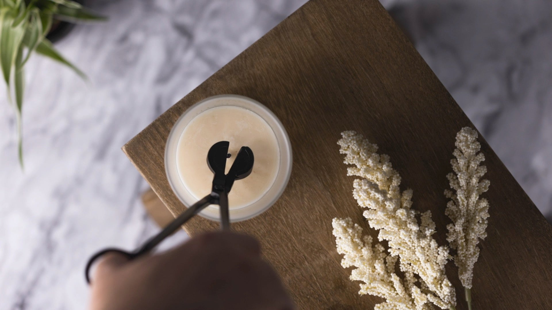 aerial view of a candle wick being trimmed