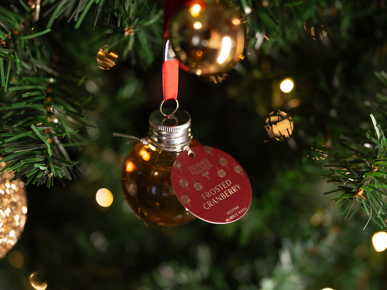 Frosted Cranberry Festive Bath Bauble Hanging on a Christmas Tree