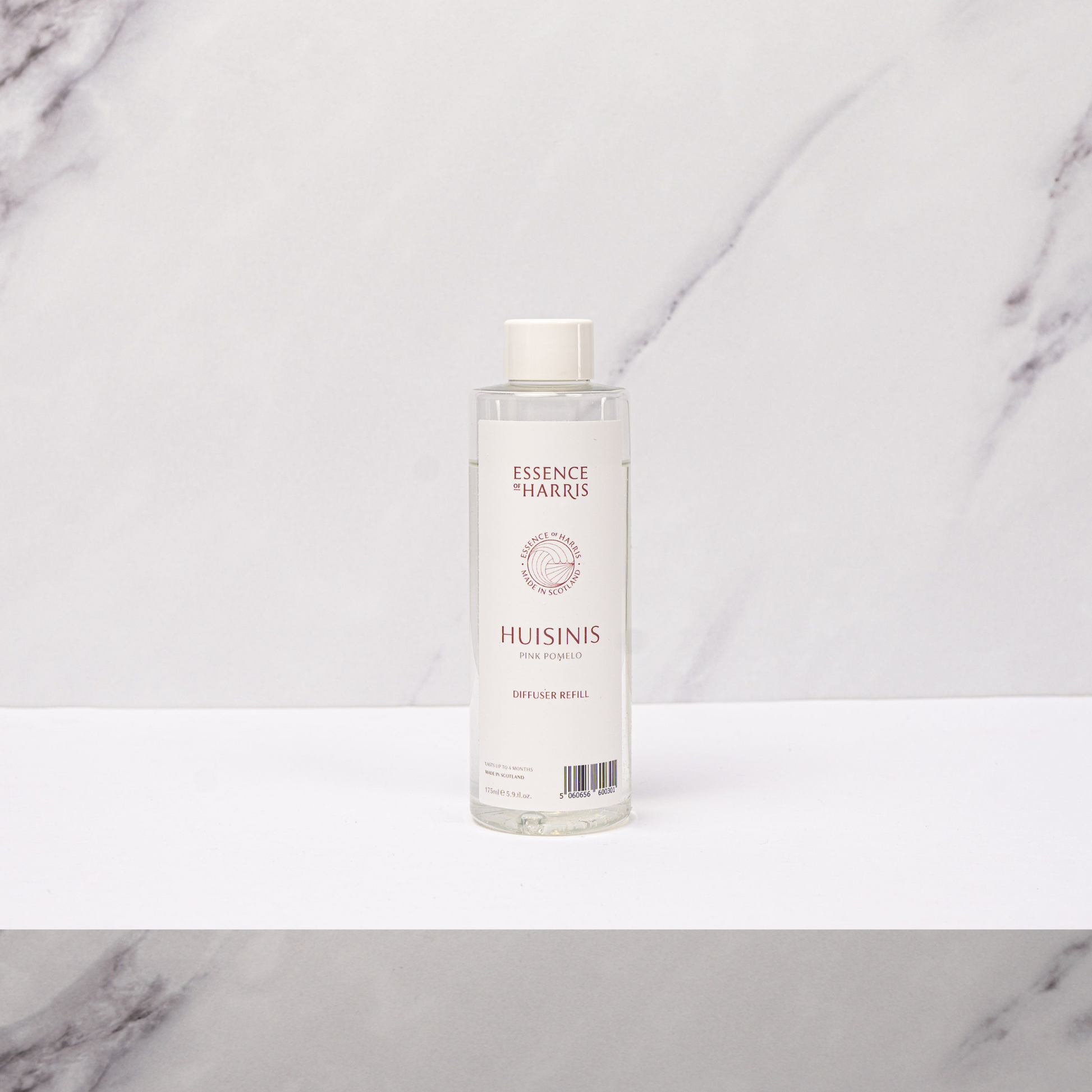 Essence of Harris Huisinis pink pomelo, grapefruit and rhubarb reed diffuser refill oil in clear plastic bottle with label and white cap