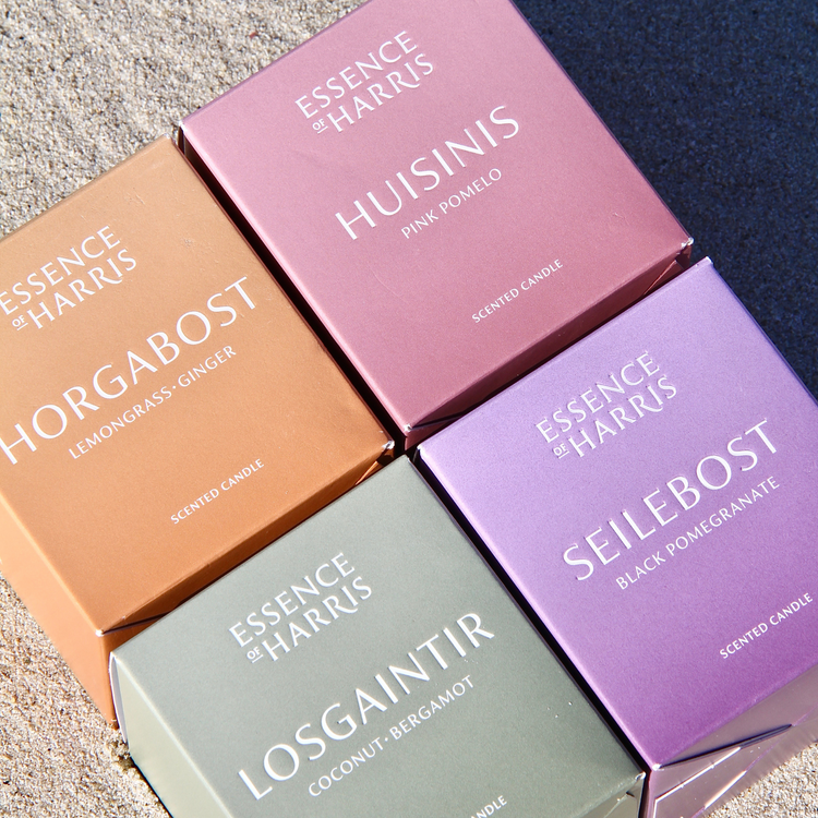 Essence of Harris candle boxes photographed on the sand