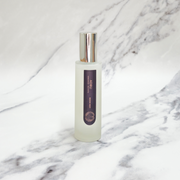 Essence of Harris Adru sandalwood and wild nettle spray on marble backdrop