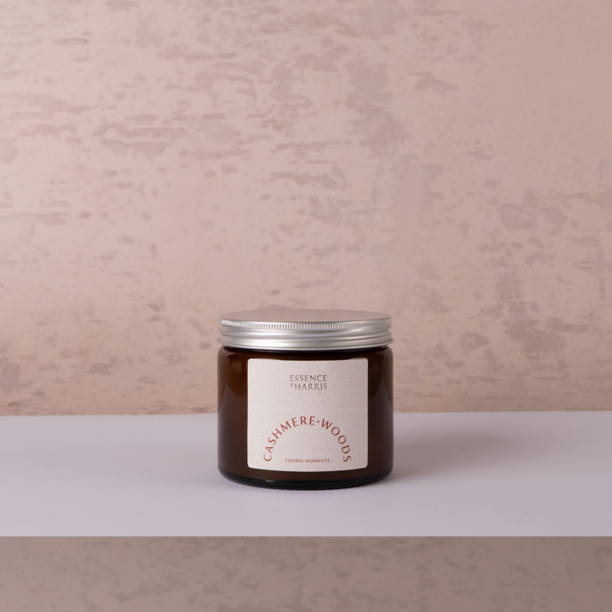 Cashmere woods jar candle with silver lid on neutral backdrop