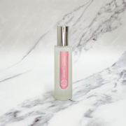 Essence of Harris Huisinis pink pomelo room spray on marble backdrop