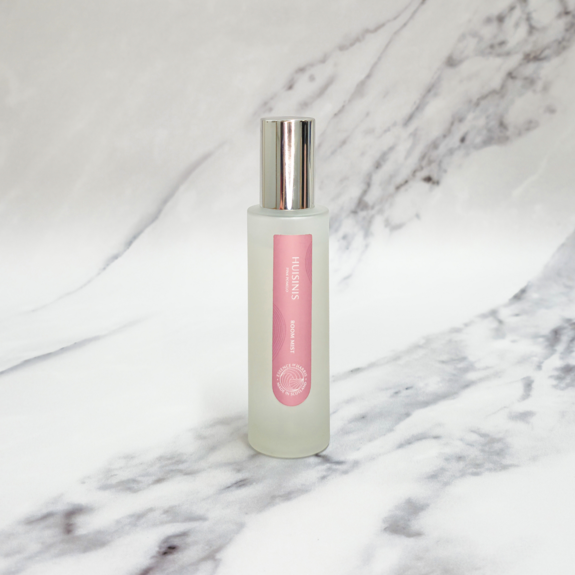 Essence of Harris Huisinis pink pomelo room spray on marble backdrop