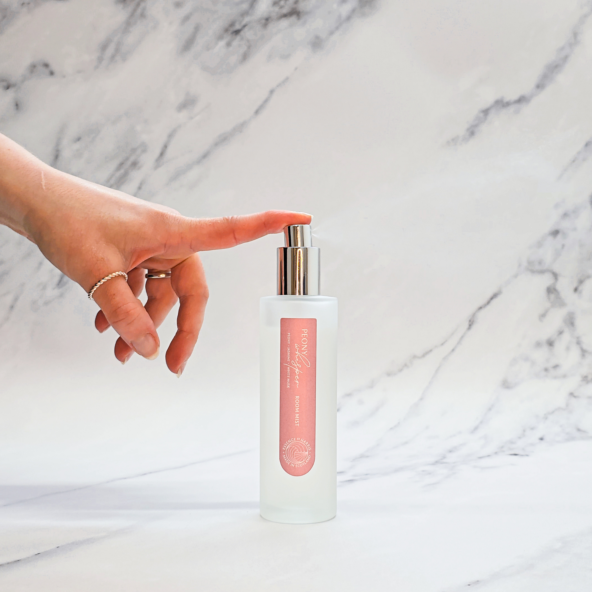 Essence of Harris Peony, jasmine and white-musk room mist in frosted glass bottle with hand spritzing spray