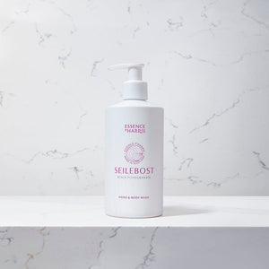 Seilebost, Black Pomegranate Hand and Body Wash in White 300ml Pump Bottle on a marble background.