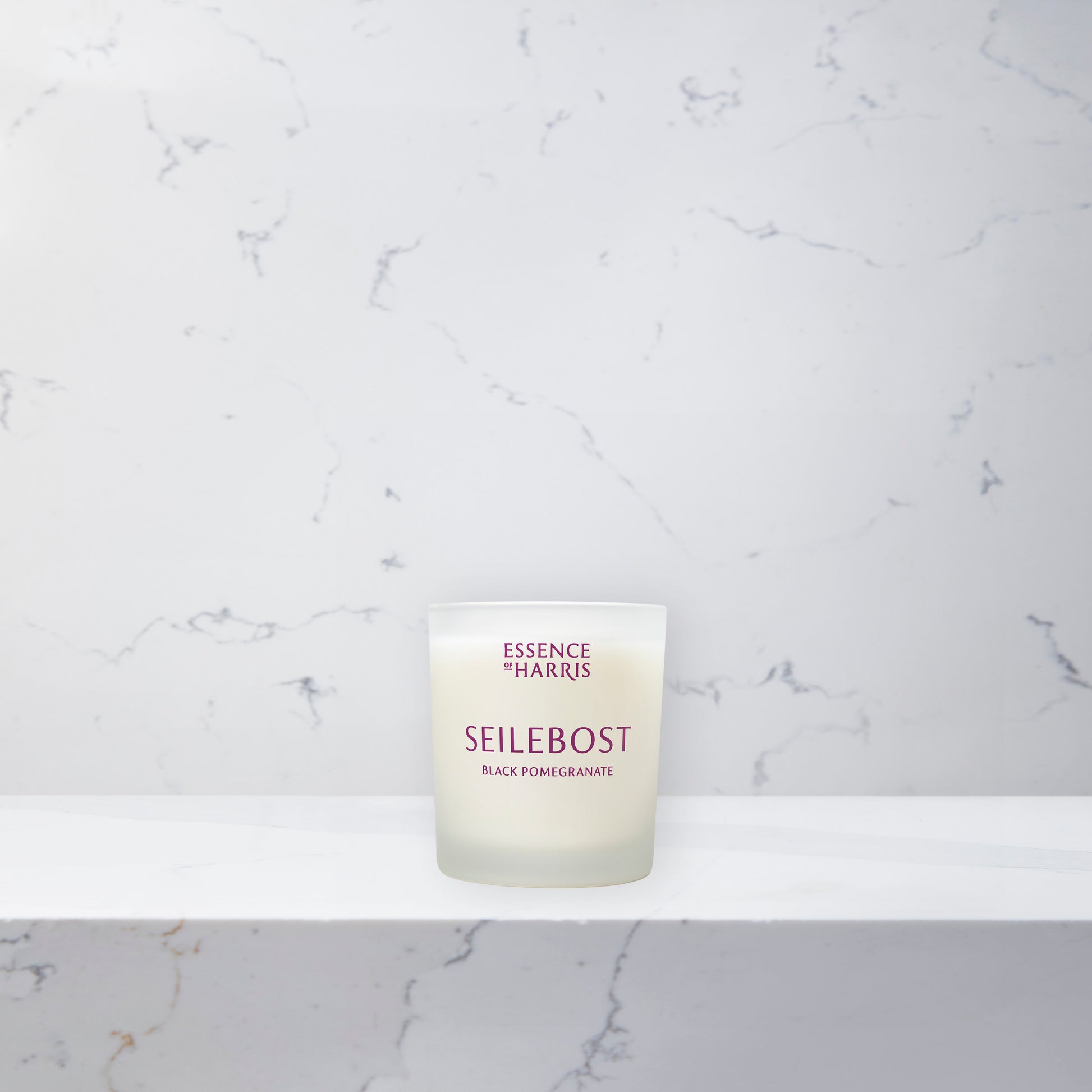 Essence of Harris black pomegranate and plum soy wax votive candle in frosted glass vessel 