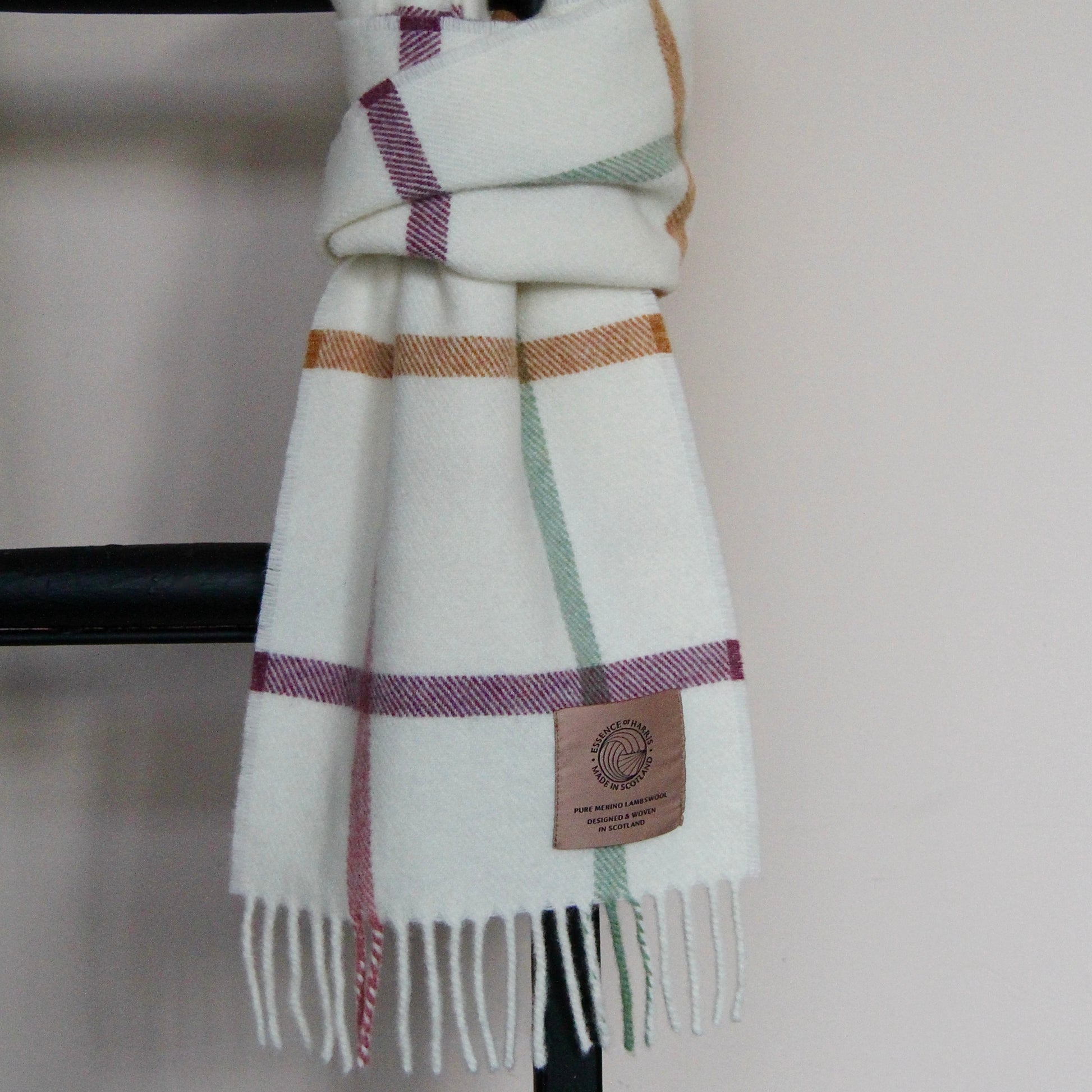 Essence of Harris, Harris Sands pastel checked lambswool scarf tied round a black ladder