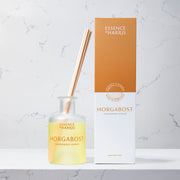 Horgabost, lemongrass and ginger reed diffuser with reeds next to orange box