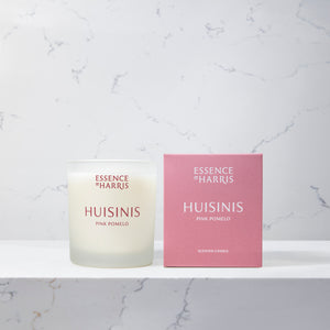 Huisinis, pink pomelo and grapefruit candle in frosted glass vessel next to pink box