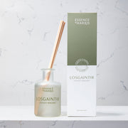 Losgaintir, coconut and bergamot frosted glass reed diffuser on marble background next to green and white box