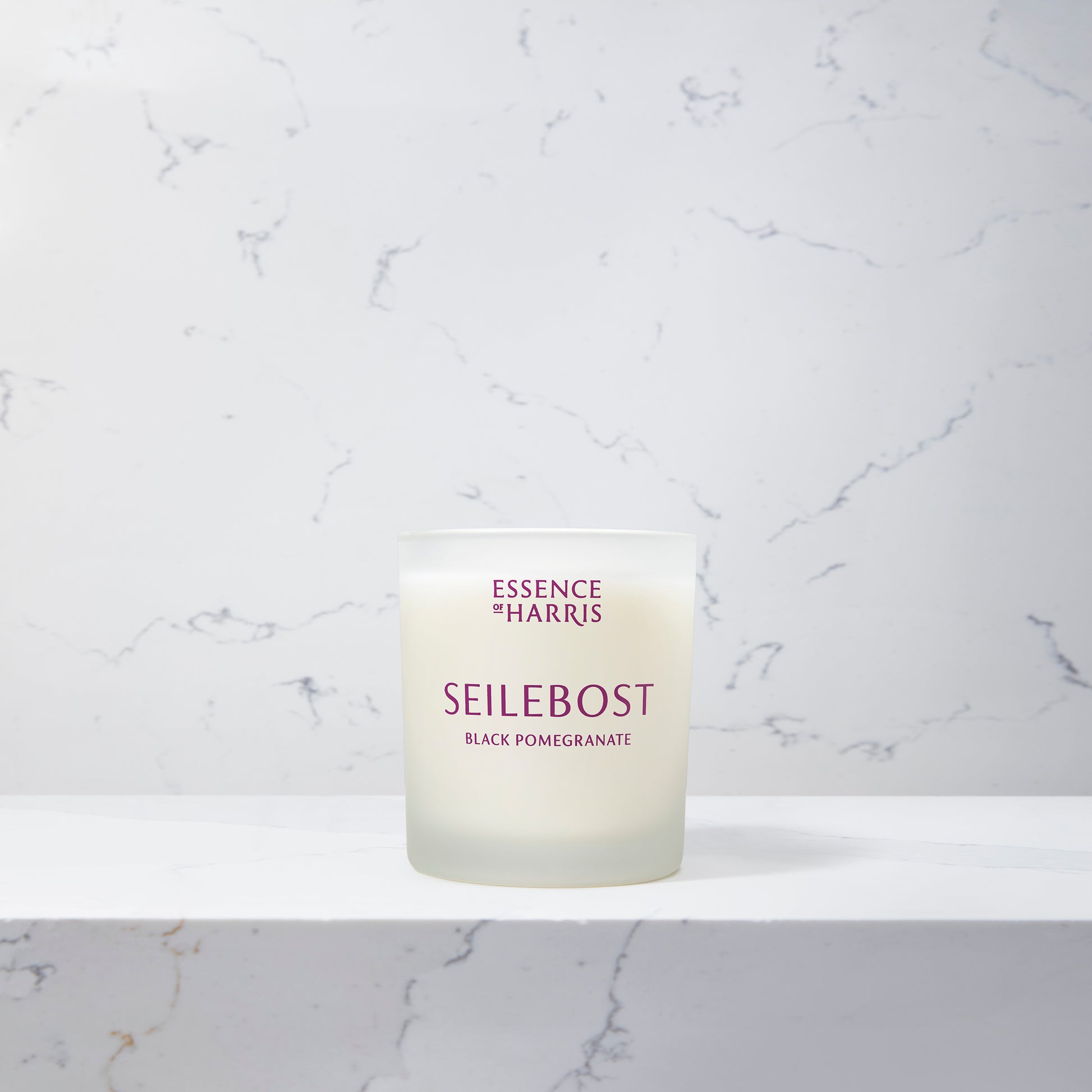 Essence of Harris Seilebost black pomegranate and plum soy wax candle in frosted glass vessel 